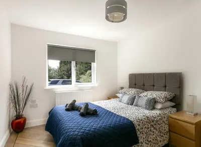 a bedroom with a bed with two teddy bears on it at Dalnahua on 'The Secret Coast'