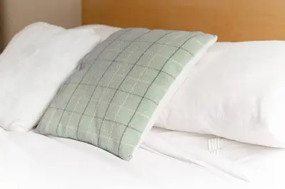 a close up of a bed with white pillows at Edinburgh City Retreat - EDINBURGH CITY CENTRE 3 min walk to Edinburgh castle in Edinburgh