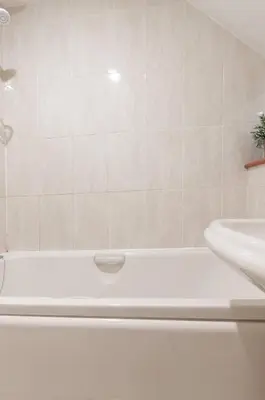 a bathroom with a white tub and a sink at Edinburgh City Retreat - EDINBURGH CITY CENTRE 3 min walk to Edinburgh castle in Edinburgh