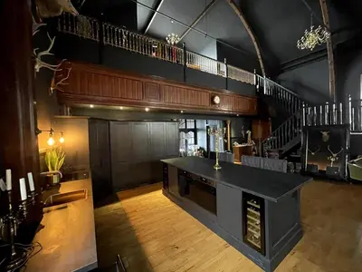 a large room with a bar and a staircase at The Old Church Isle of Bute in Port Bannatyne