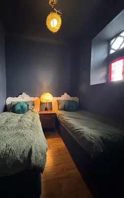a bedroom with two beds and a window at The Old Church Isle of Bute in Port Bannatyne