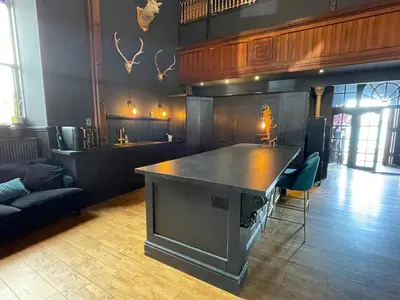 a room with a large island in the middle of a room at The Old Church Isle of Bute in Port Bannatyne