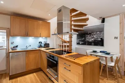 a kitchen with a sink and a stove top oven at Little Juniper Lodge in Edinburgh