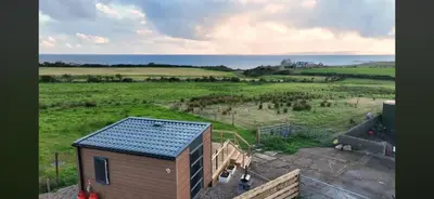 an aerial view of a tiny house in a field at Cnocanreoch Farm Glamping in Kilmory