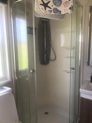 a shower with a glass door in a bathroom at Cnocanreoch Farm Glamping in Kilmory