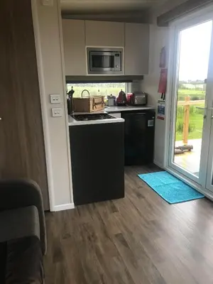 a kitchen with a stove top oven next to a door at Cnocanreoch Farm Glamping in Kilmory