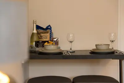 a table with two glasses and a bottle of wine at Tigh Na Cille Studio in Taynuilt