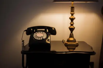 a phone sitting on a table next to a lamp at Islay House in Bridgend