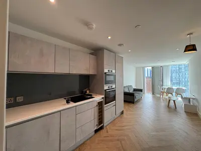 a kitchen with stainless steel appliances and a living room at victoria resedent in Moffat