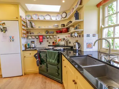 a kitchen with a sink and a refrigerator at Townhead of Auchenbainzie in Thornhill