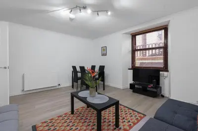 a living room with a couch and a table at Free Parking - Sleeps 6 - Central - New Interior in Greenock