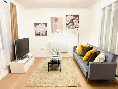a living room with a couch and a tv at Lovely 1-bedroom Apt in Glasgow City near Subway in Glasgow