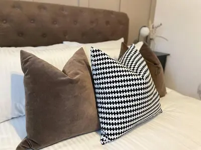 two pillows sitting on top of a bed at Lovely 1-bedroom Apt in Glasgow City near Subway in Glasgow