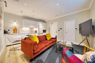 a living room with a couch and a table at City Oasis Craigpark Residence in Glasgow