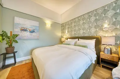 a bedroom with a large white bed in a room at City Oasis Craigpark Residence in Glasgow