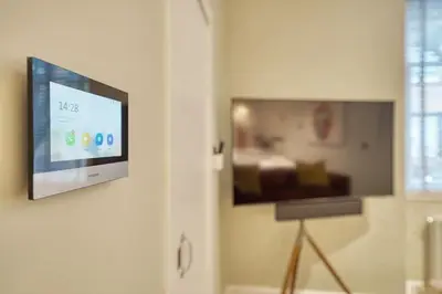a flat screen tv hanging on a wall at City Oasis Craigpark Residence in Glasgow