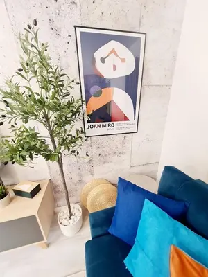 a living room with a blue couch and a plant at Modern Apartment - FREE parking in Glasgow