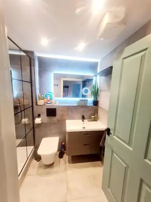 a bathroom with a sink and a toilet and a mirror at Modern Apartment - FREE parking in Glasgow