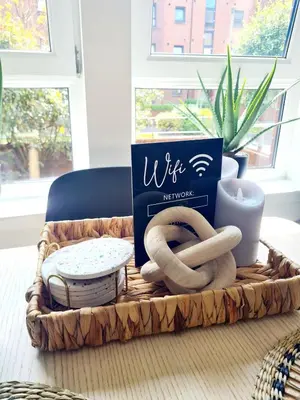 a basket with a book and two pretzels on a table at Modern Apartment - FREE parking in Glasgow