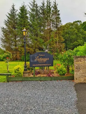a sign in a park with a street light at Lakeside Lodge - Lakeside Lodge Retreat - Golf & Spa, Gleneagles in Dunning