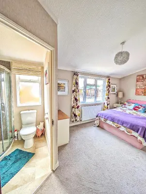 a bedroom with a bed and a toilet and windows at Lakeside Lodge Retreat, with Roof Deck - Golf & Spa, Gleneagles