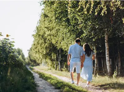 a man and a woman walking down a dirt road at Lakeside Lodge Retreat, with Roof Deck - Golf & Spa, Gleneagles