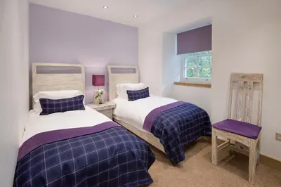 a bedroom with two beds and a window at Arrochar House in Tarbet