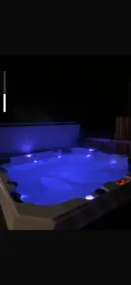 a blue bath tub in a dark room at Hunters Quay - Hot Tub Lodge at Limecroft 6 in Hunters Quay