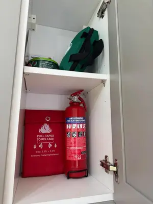 a red fire hydrant sitting inside of a cabinet at Hunters Quay - Hot Tub Lodge at Limecroft 6 in Hunters Quay