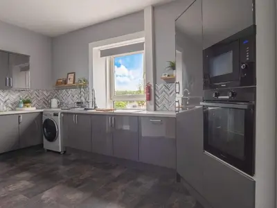 a kitchen with stainless steel appliances and a window at Pitchside Escape in Ayr