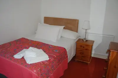 a bedroom with a bed with white towels on it at Grassmarket-Old Town Apartment in Edinburgh
