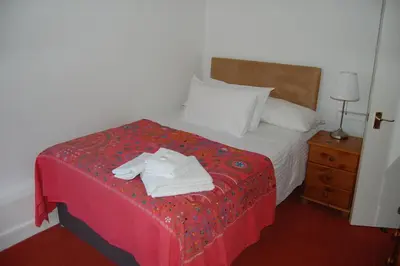 a hotel room with a bed with towels on it at Grassmarket-Old Town Apartment in Edinburgh