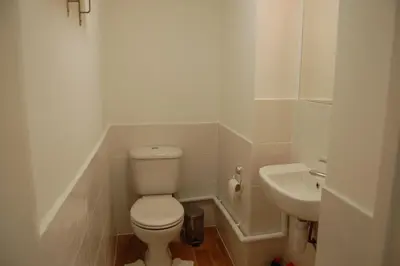 a white bathroom with a toilet and a sink at Grassmarket-Old Town Apartment in Edinburgh