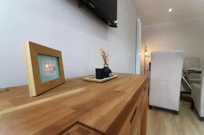 a wooden counter with a picture and a vase on it at Signature - Wellhead View in Lanark
