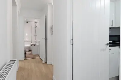 a hallway with white walls and a bathroom at Free Parking - Sleeps 6 - 2 Bedrooms - Newly Renovated in Greenock