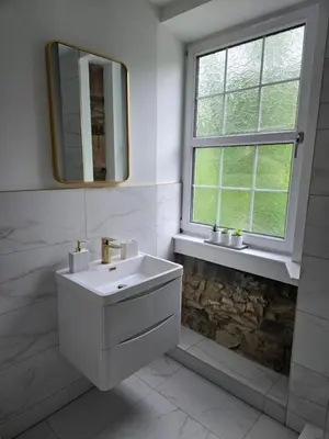 a white bathroom with a sink and a window at Ben Lomond Apartment in Tarbet