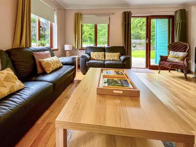 a living room with a couch and a coffee table at Foxglove Cottage 1 - Uk50019 in Drymen