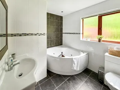 a white bathroom with a tub and a sink at Foxglove Cottage 1 - Uk50019 in Drymen