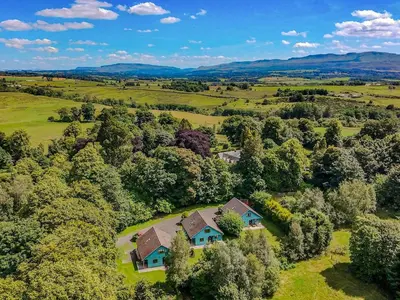 an aerial view of a house in a field at Foxglove Cottage 1 - Uk50019 in Drymen