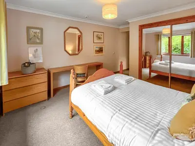 a bedroom with a bed and a mirror at Foxglove Cottage 1 - Uk50019 in Drymen