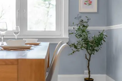 a kitchen with a table with glasses and a plant at Free Parking - Central - Sleeps 8 - 3 Bedrooms in Livingston