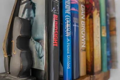 a book shelf with books on it at Free Parking - Central - Sleeps 6 - 2 Bedrooms in East Calder