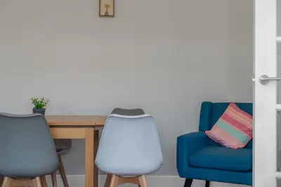 a dining room with a table and chairs at Free Parking - Central - Sleeps 6 - 2 Bedrooms in Livingston