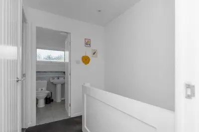 a white bathroom with a toilet and a sink at Free Parking - Central - Sleeps 6 - 2 Bedrooms in Livingston