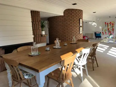 a dining room with a wooden table and chairs at Edinburgh whole house let for DP World Tour, overlooking Bruntsfield Links 18th fairway, 30 min drive from The Renaissance Club in Edinburgh