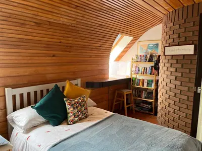a bedroom with a bed and a book shelf at Edinburgh whole house let for DP World Tour, overlooking Bruntsfield Links 18th fairway, 30 min drive from The Renaissance Club in Edinburgh