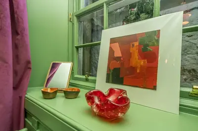 a table with a red heart on it next to a painting at New Town Cottage in Edinburgh