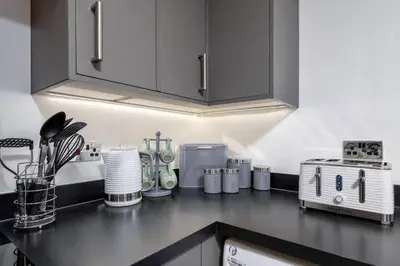 a kitchen with a counter top with a stove at Modern Comfort in Historic Callander in Stirling