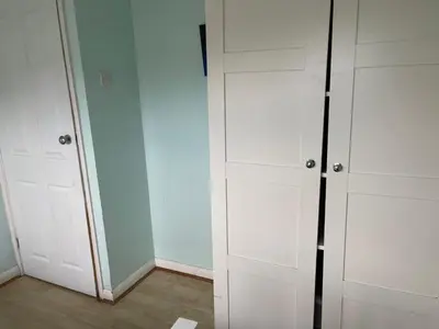 a white closet with white cabinets and a mirror at Home Sweet Home in Moffat