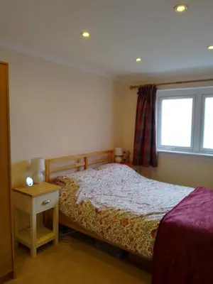 a bedroom with a bed and a window at Comfortable room with en suite in Edinburgh